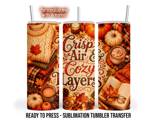 Three tumbler views show Crisp Air and Cozy Layers lettering surrounded by sweaters, coffee, pumpkins, candles, books and autumn leaves.