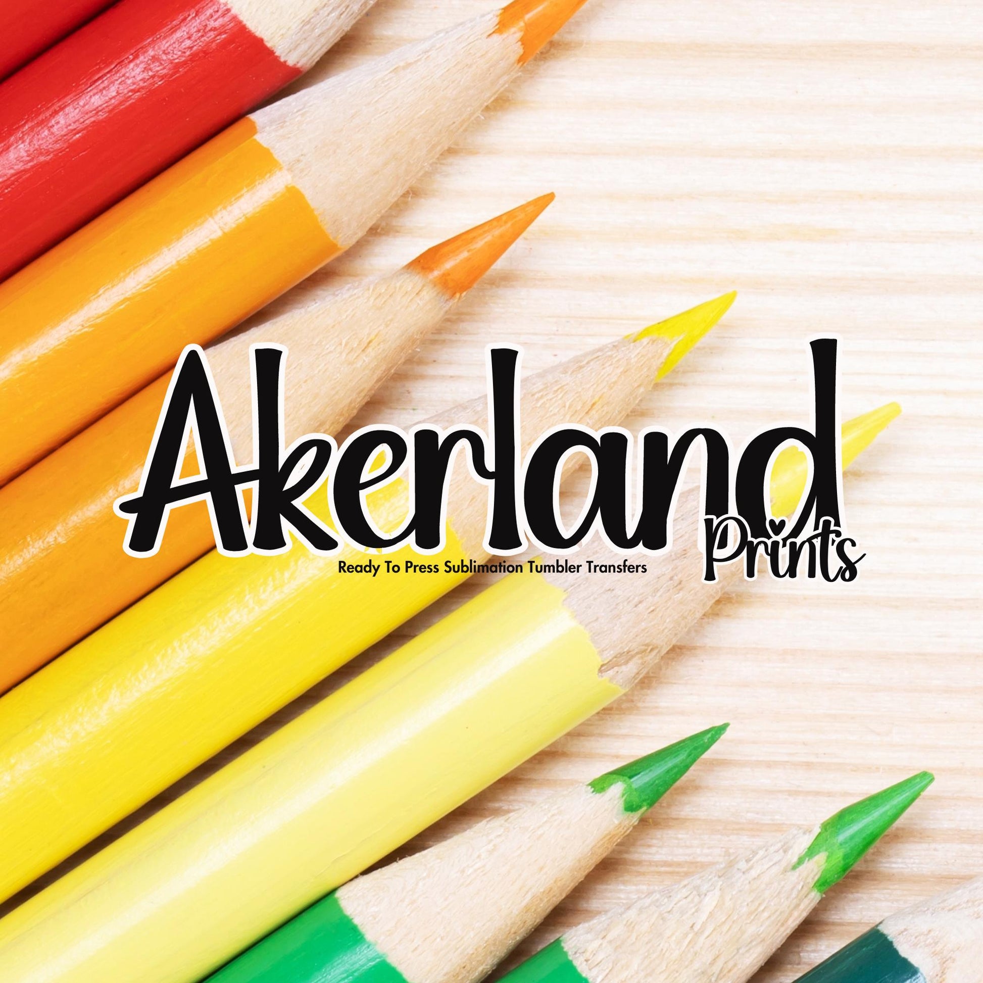 a group of colored pencils sitting on top of a wooden table