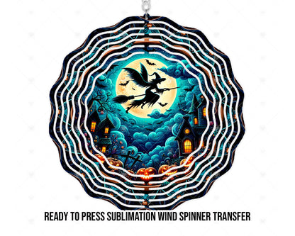 Mockup of Halloween artwork for a physical printed sublimation transfer, shown on a scalloped wind spinner shape. A black witch silhouette rides a broom across a yellow full moon, surrounded by bats, swirling teal clouds, crooked haunted houses with orange-lit windows, and jack-o’-lanterns. The product is the transfer, not a finished spinner or digital file.
