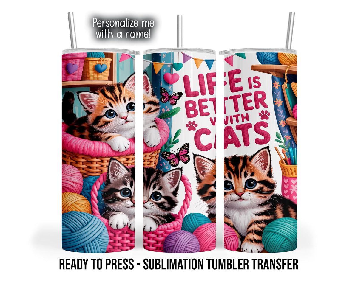 Three tumbler mockup views show orange, black, and white kittens nestled in pink-lined woven baskets among pink, teal, blue, yellow, and purple yarn balls. Butterflies, hanging hearts, bunting, and floral accents surround pink lettering reading “Life is better with cats.”